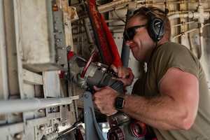 U.S. Air Force Senior Airman Alex Bengel, 350th Air Refueling Squadron boom operator, connects a fuel hose to a KC-135 Stratotanker aircraft at McConnell Air Force Base, Kansas, July 8, 2025. While ground fueling is typically conducted by logistics Airmen, boom operators were instructed on fueling and basic maintenance procedures as they provided critical air refueling support to the Air Force's 2025 Department-Level Exercise series. The DLE series encompasses all branches of the Department of Defense, along with Allies and partners, employing more than 400 Joint and coalition aircraft and more than 12,000 members at more than 50 locations across 3,000 miles (U.S. Air Force photo by Tech. Sgt. Nathan Eckert)