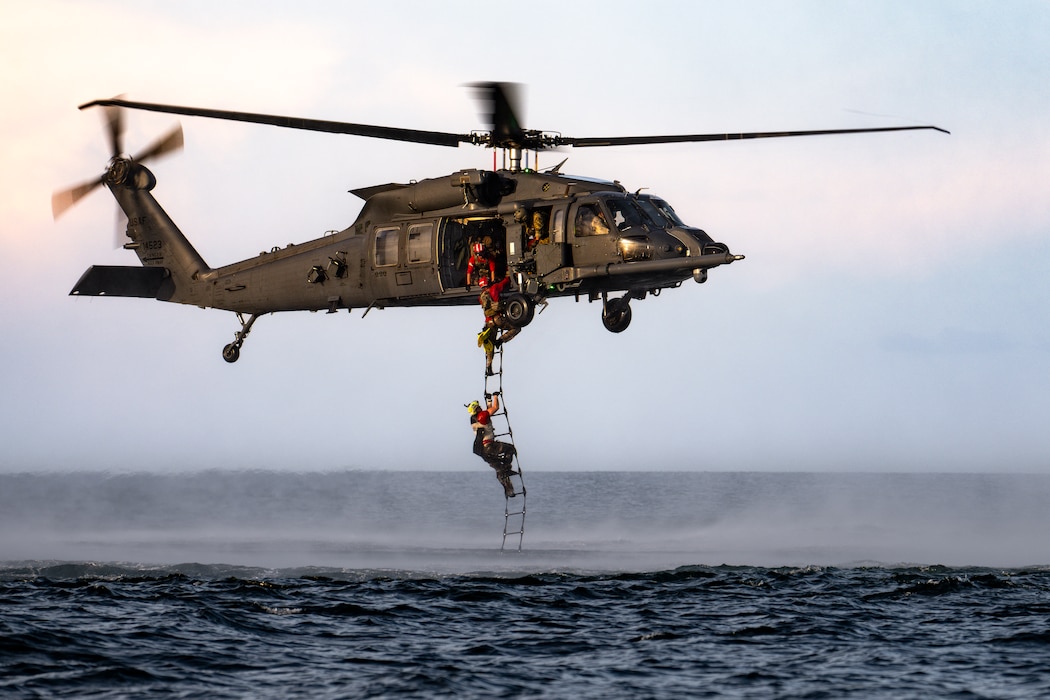 photo of people climbing a ladder into a helicopter