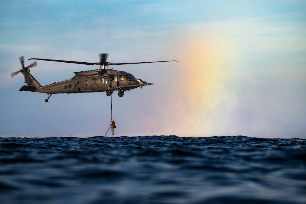 photo depicting people fast roping from a helicopter