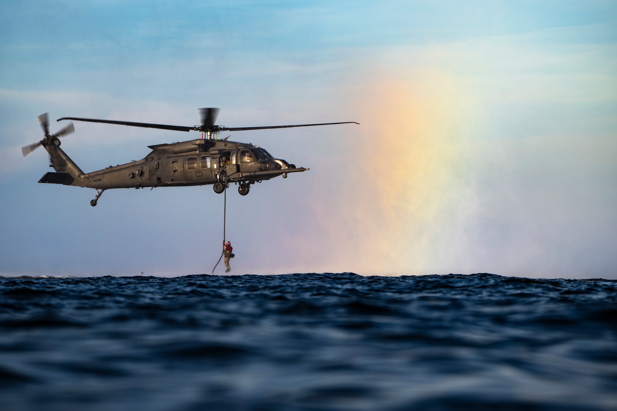 photo depicting people fast roping from a helicopter
