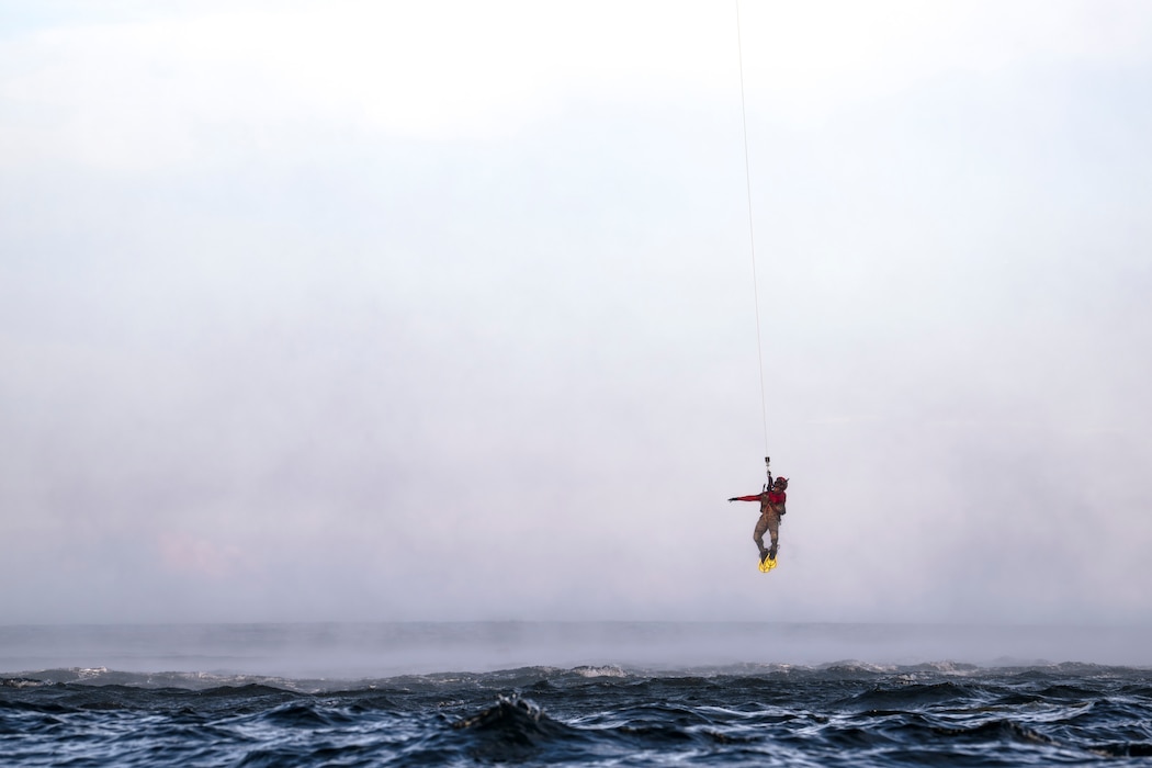 photo depicting people being hoisted into a helicopter