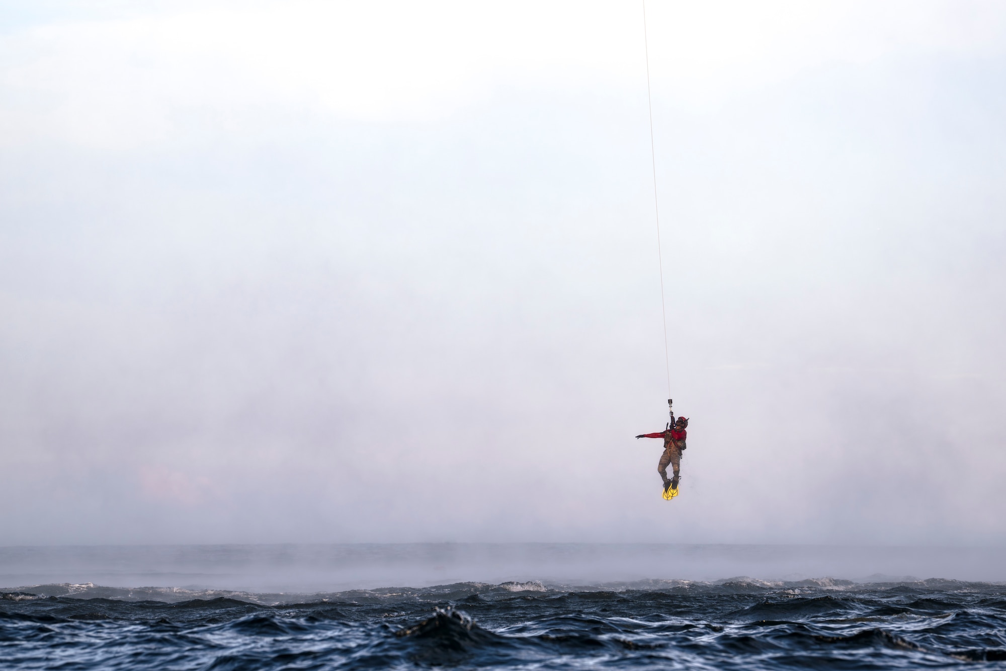 photo depicting people being hoisted into a helicopter