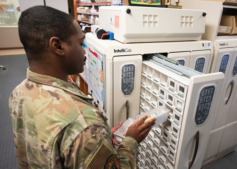An Airman stores away filled medications.