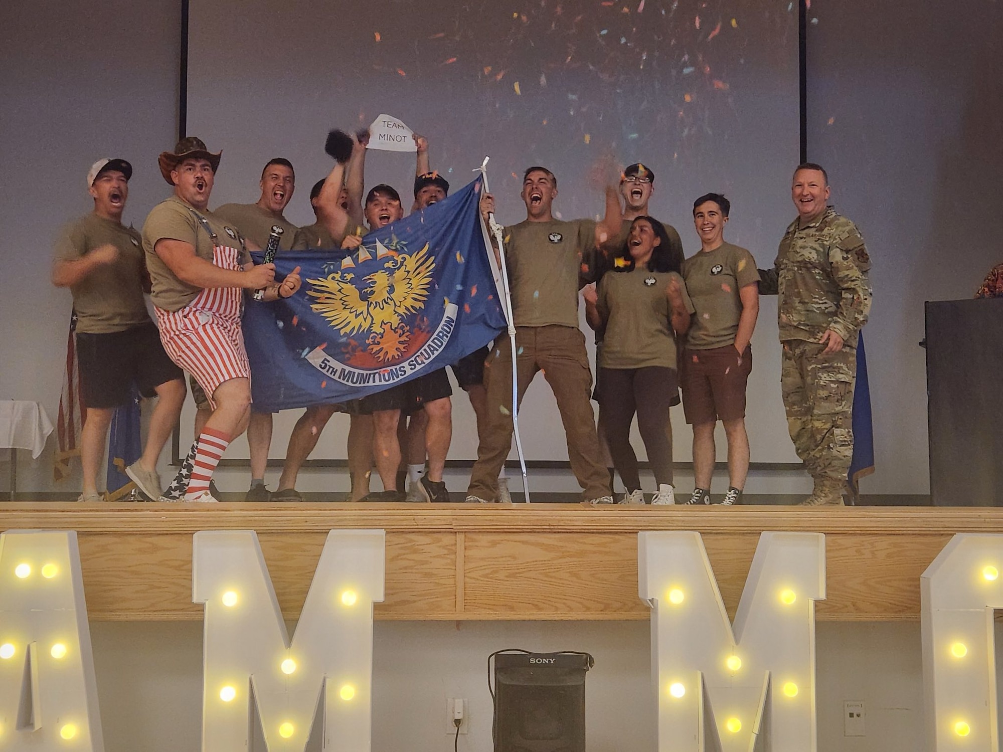 U.S. Air Force Airmen from the 5th Munitions (5MUNS) celebrate during the 2025 Air Force Combat Operations Competition at Beale Air Force Base, California, August 15, 2025. 5MUNS won 1st place this year for Team Minot.