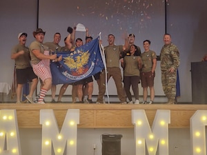 U.S. Air Force Airmen from the 5th Munitions (5MUNS) celebrate during the 2025 Air Force Combat Operations Competition at Beale Air Force Base, California, August 15, 2025. 5MUNS won 1st place this year for Team Minot.