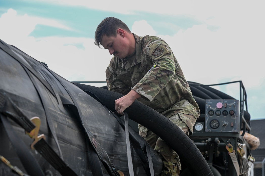 A service member holds a pump.