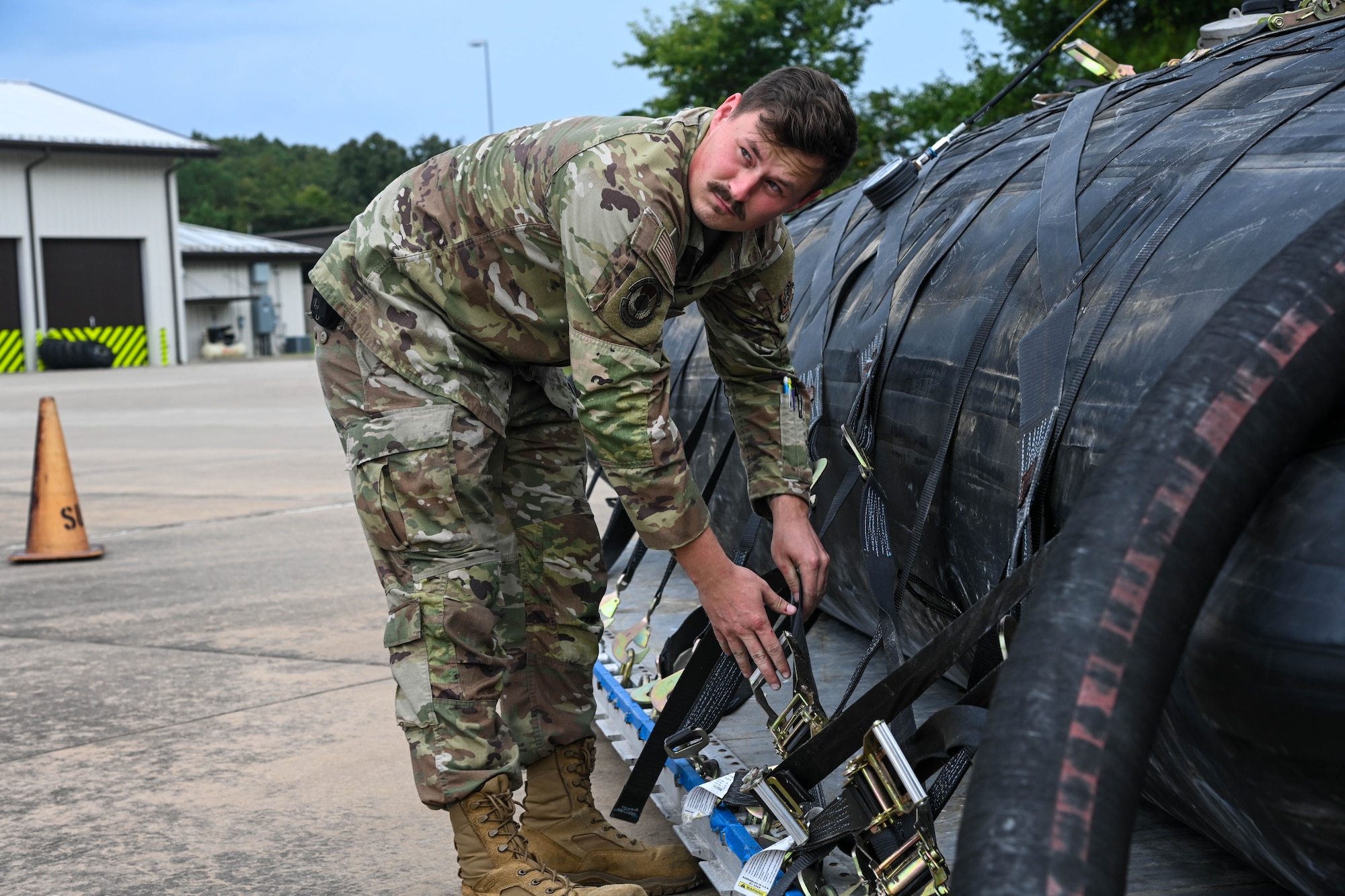 A service member works on equipment.