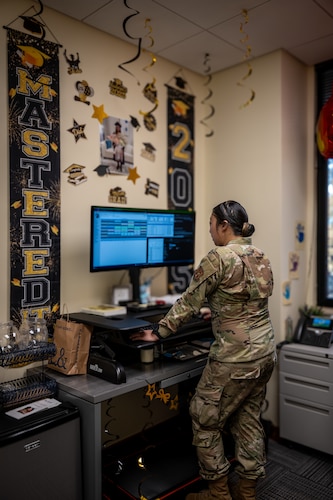 U.S. Air Force Staff Sgt. Michelle Moua, a Squadron Aviation Resource Management (SARM) specialist assigned to the 70th Aerial Refueling Squadron, performs her duties at Travis AFB, Calif., August 20, 2025. In her workspace, Moua is surrounded by celebratory decoration for her Master's education achievement. Moua was recognized with the American Red Cross Service to Armed Forces Award on June 7, 2025 for her volunteer work at David Grant Medical Center. She also recently completed a Master's Degree in Public Health Administration and continues to serve with excellence as a Reserve Airman in the Air Force Reserve.