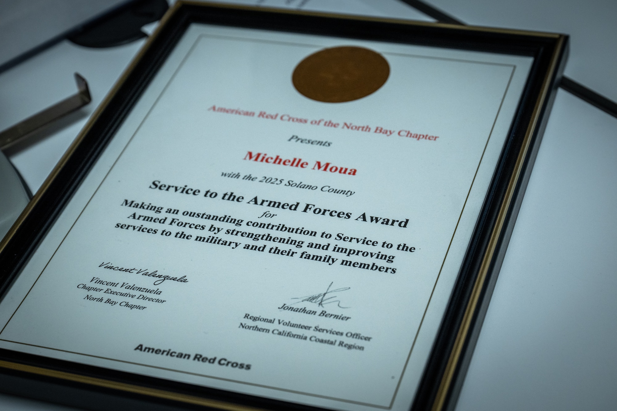 The American Red Cross Service to the Armed Forces Award presented to U.S. Air Force Staff Sgt. Michelle Moua, a Squadron Aviation Resource Management specialist assigned to the 70th Aerial Refueling Squadron, is displayed at Travis AFB, Calif., August 20, 2025. Moua was recognized with the American Red Cross Service to Armed Forces Award on June 7, 2025 for her volunteer work at David Grant Medical Center. She also recently completed a Master's Degree in Public Health Administration and continues to serve with excellence as a Reserve Airman in the Air Force Reserve.