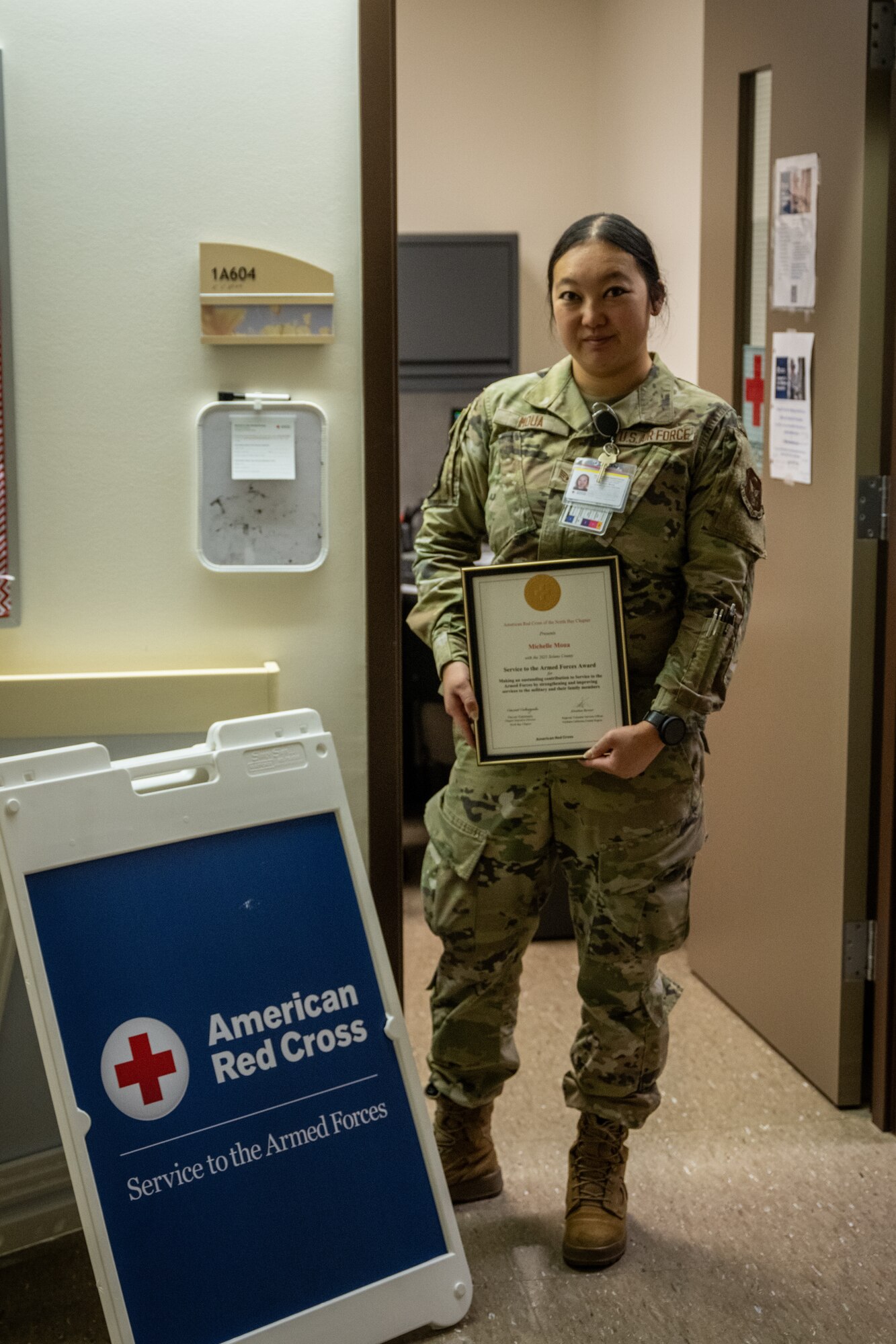 U.S. Air Force Staff Sgt. Michelle Moua, a Squadron Aviation Resource Management specialist assigned to the 70th Aerial Refueling Squadron, poses for a photo with her American Red Cross Service to Armed Forces Award at Travis AFB, Calif., August 20, 2025. Moua was recognized with the American Red Cross Service to Armed Forces Award on June 7, 2025 for her volunteer work at David Grant Medical Center. She also recently completed a Master's Degree in Public Health Administration and continues to serve with excellence as a Reserve Airman in the Air Force Reserve.