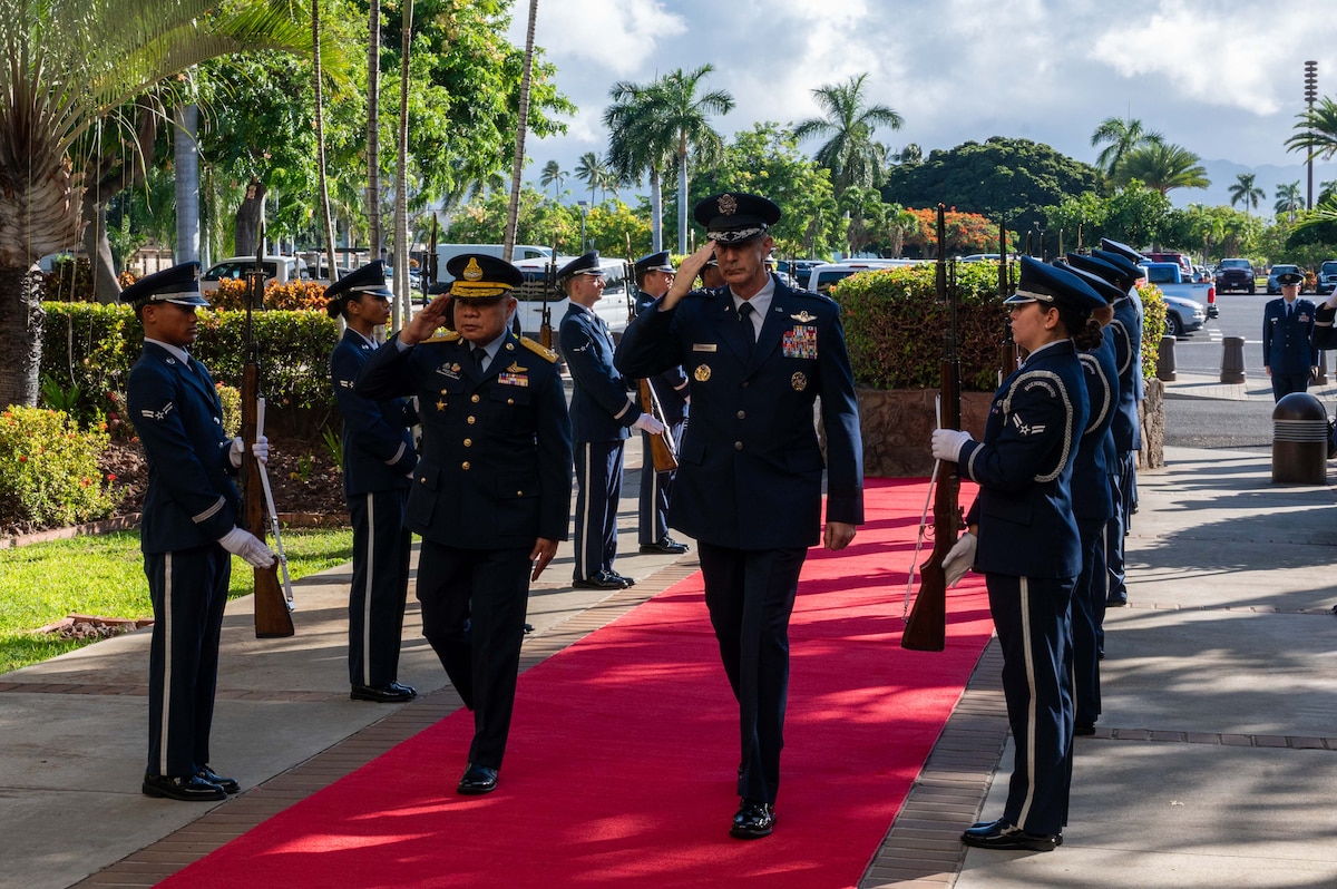Gen. Kevin B. Schneider, Commander of Pacific Air Forces, and Air Chief Marshal Panthpakdee Pattanakul, Commander of the Royal Thai Air Force (RTAF), salute an honor cordon entering Pacific Air Force Headquarters, Joint Base Pearl-Harbor Hickam, Aug. 18, 2025.