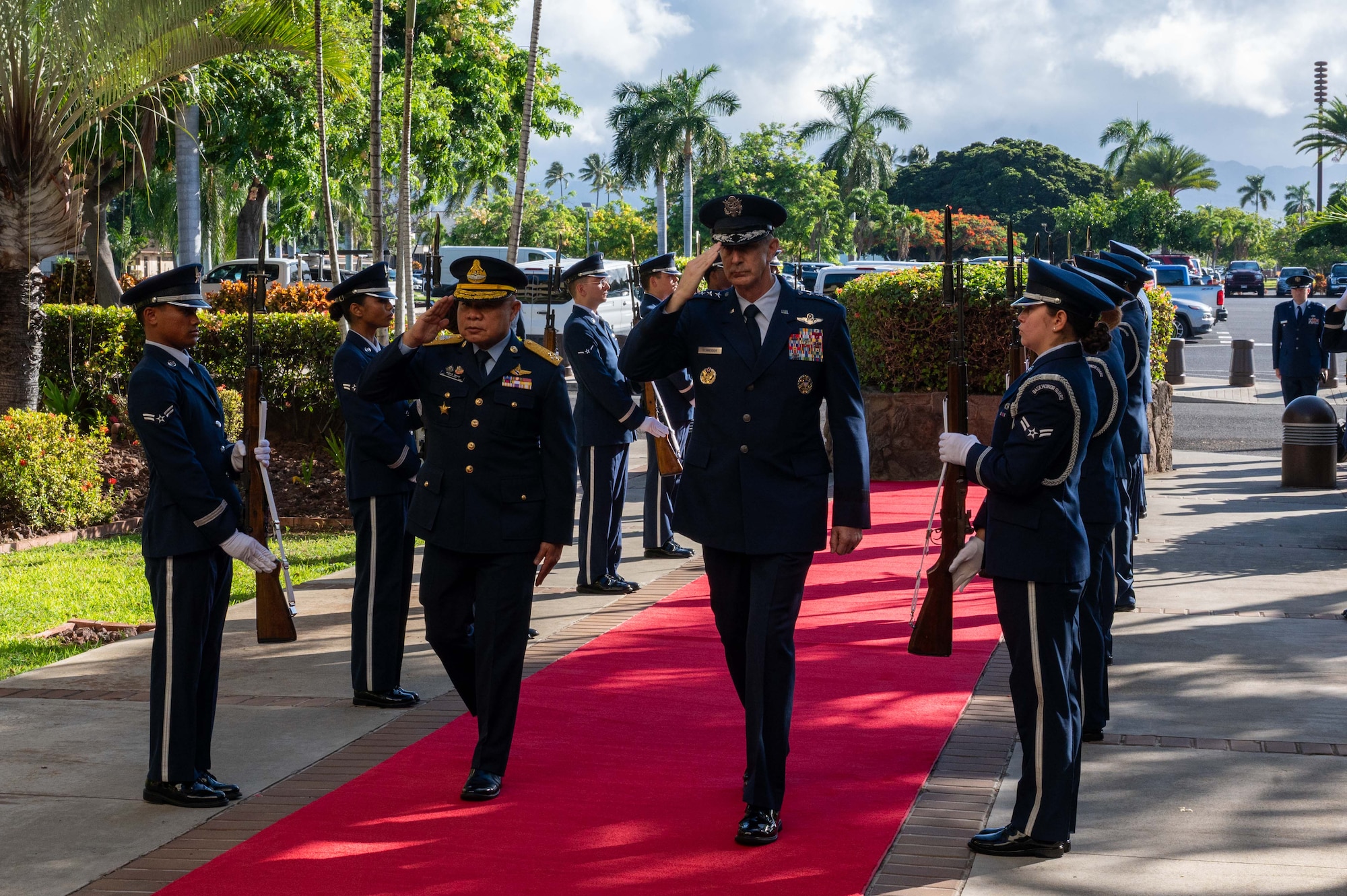 Gen. Kevin B. Schneider, Commander of Pacific Air Forces, and Air Chief Marshal Panthpakdee Pattanakul, Commander of the Royal Thai Air Force (RTAF), salute an honor cordon entering Pacific Air Force Headquarters, Joint Base Pearl-Harbor Hickam, Aug. 18, 2025.
