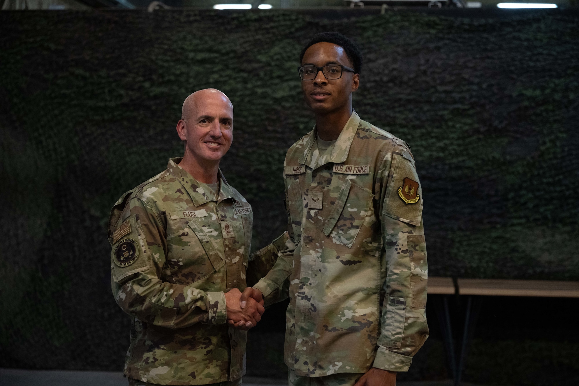 Chief Master Sgt. of the Air Force David Flosi, recognizes U.S. Air Force Airman 1st Class Gaffney Hargis, 39th Communications Squadron cable and antenna technician, during a visit to Incirlik Air Base, Türkiye, August 14, 2025.