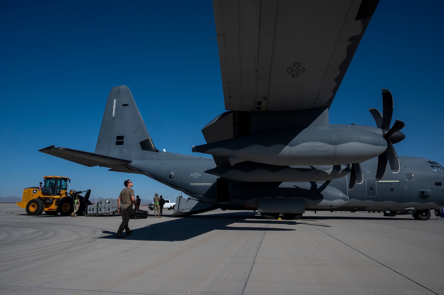 U.S. Airmen assigned to Air Force Special Operations Command onloads cargo onto a U.S. Air Force MC-130J Commando II during Emerald Warrior 25.2 at Marine Corps Air Station, Yuma, July 30, 2025.