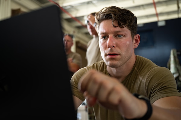 U.S. Air Force Staff Sgt. Bryce Hirigoyen, 138th Electromagnetic Warfare Squadron, Colorado Air National Guard, looks at data during exercise Resolute Space 2025 at the Guam National Guard Readiness Center, Guam, July 16, 2025.