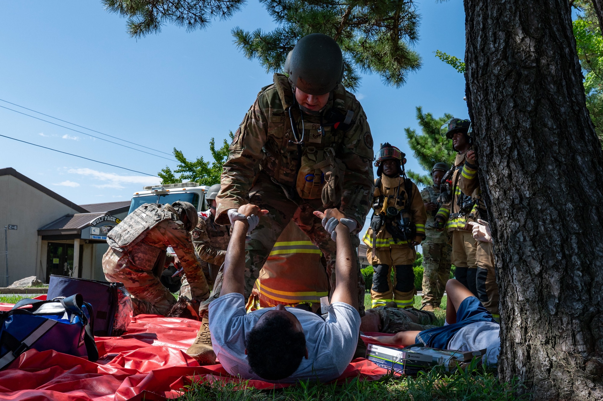 A combat medic picks up a simulated casualty