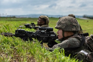 A Republic of Korea Air Force airman takes a
defensive position alongside 51st Fighter Wing
Airmen while responding to a simulated ground attack
during Ulchi Freedom Shield 25 at Osan Air Base,
Republic of Korea, Aug. 19, 2025.