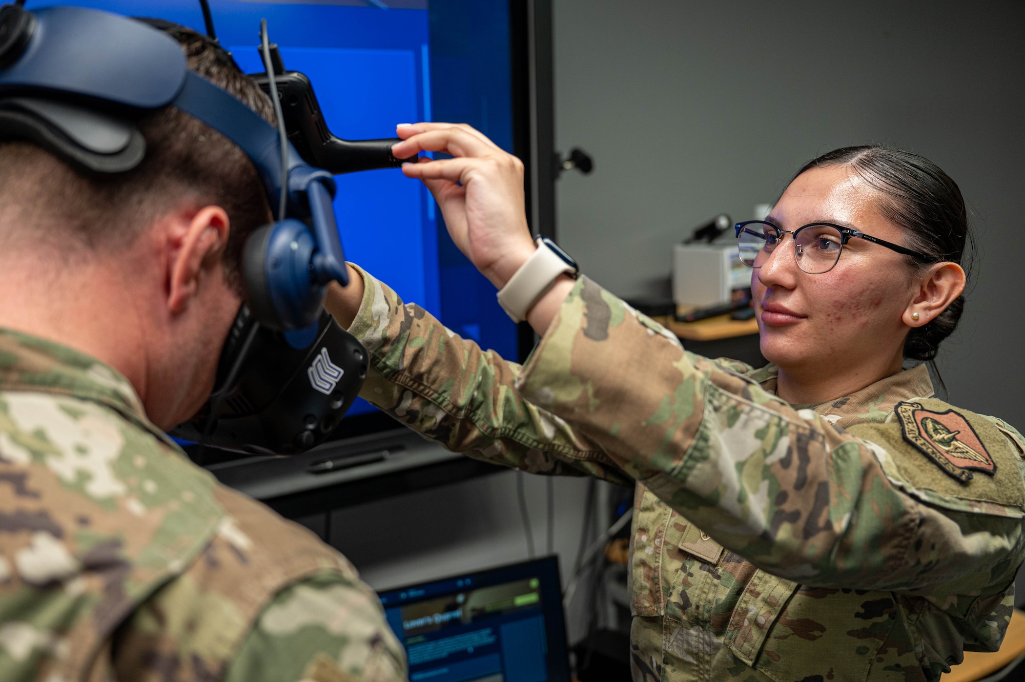 U.S. Air Force Senior Airman Marlinda Montoya, 35th Security Forces Squadron (SFS) unit training manager, adjusts a virtual reality (VR) headset prior to a training demonstration at Misawa Air Base, Japan, Aug. 11, 2025.