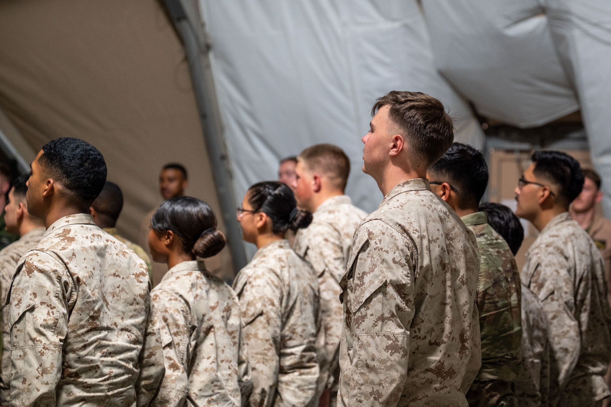 U.S. Marines and Airmen deliver the noncommissioned officer charge upon graduating a Corporals Course.
