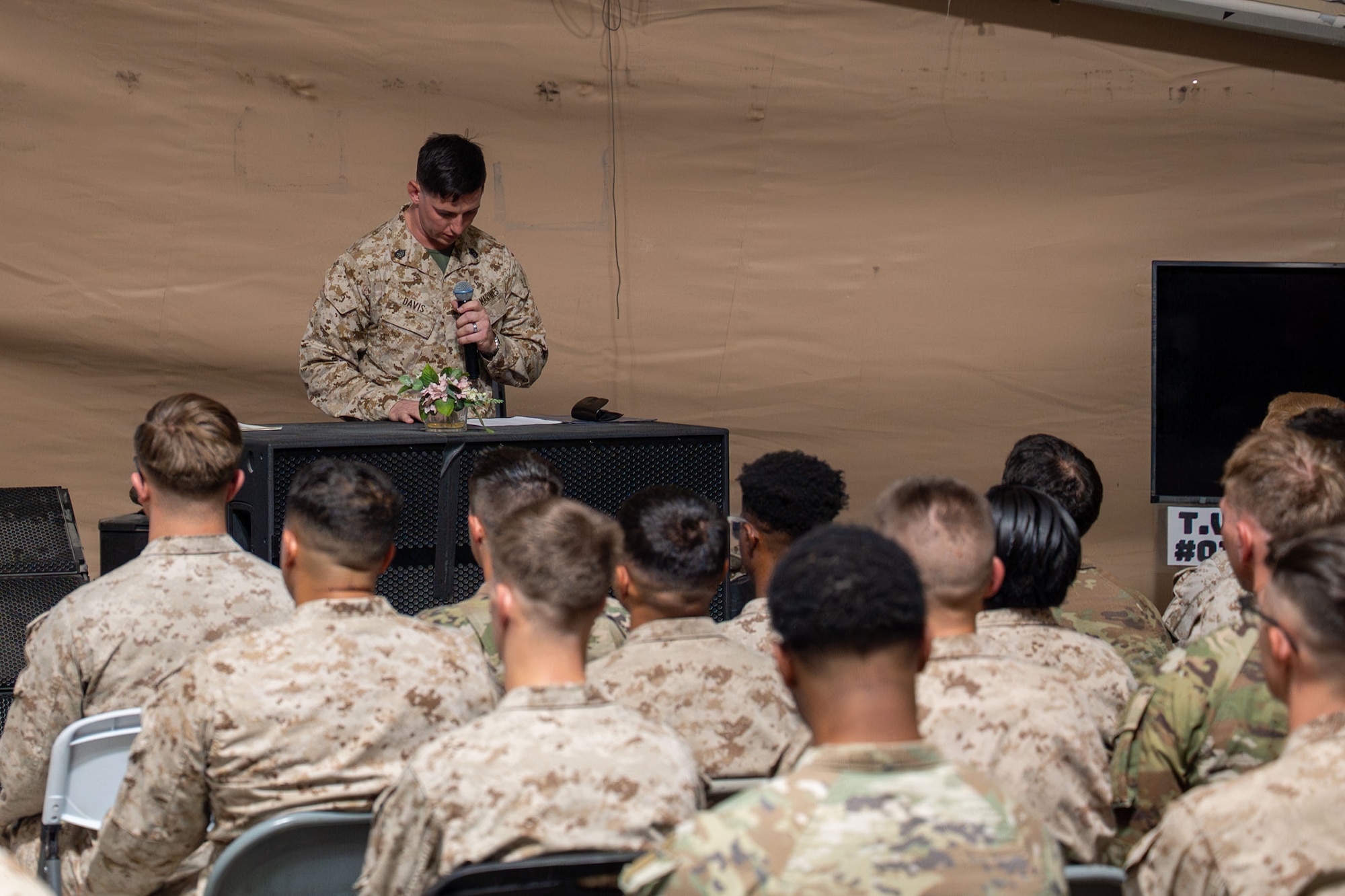 U.S. Marine Corps Gunnery Sgt. Christopher Davis, 378th AEW Corporals Course graduation ceremony narrator, delivers opening remarks at a Corporals Course graduation.