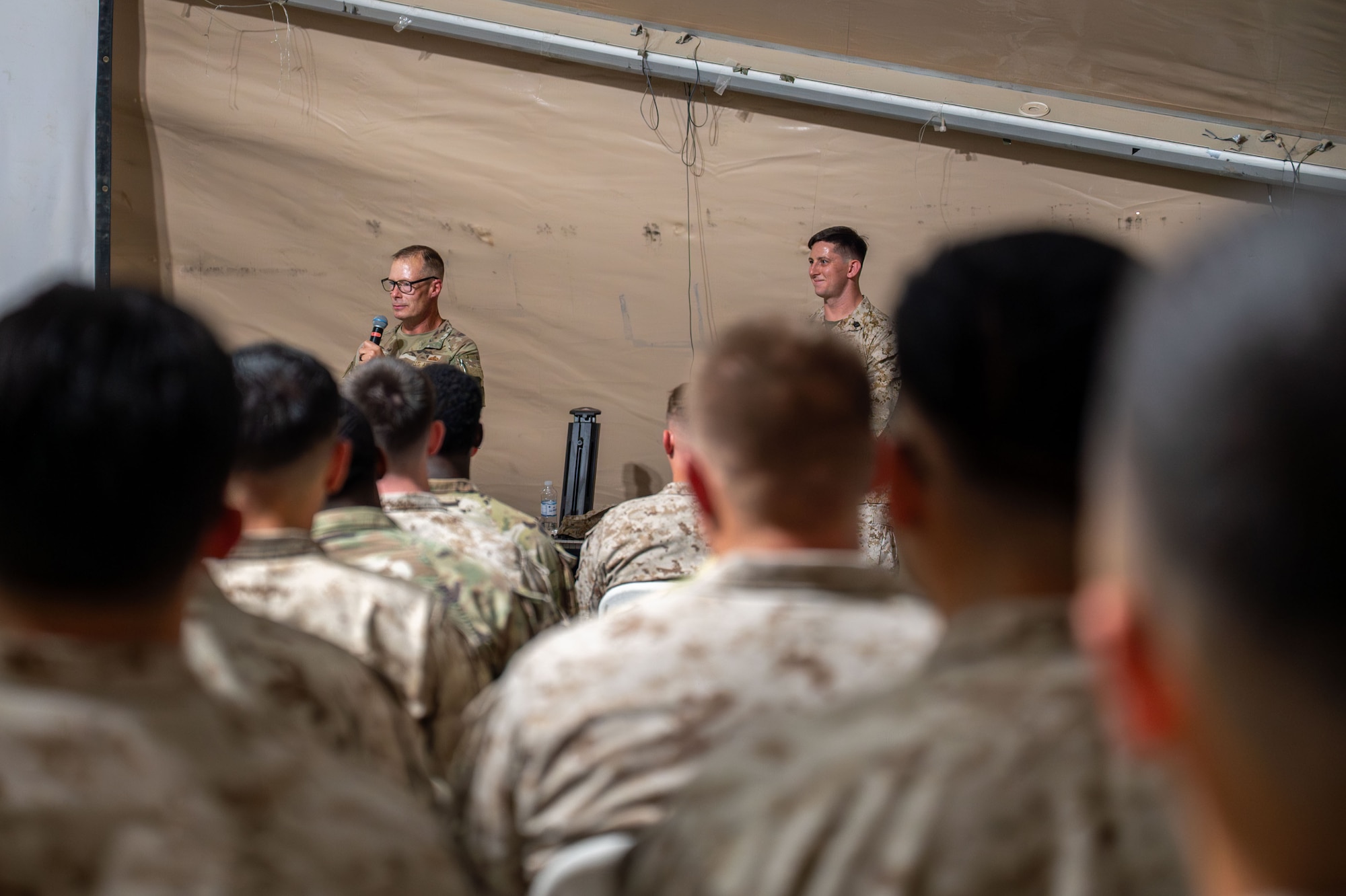 U.S. Air Force Chief Master Sgt. Christopher Griste, 378th Air Expeditionary Wing command chief, speaks at a Corporals Course graduation.