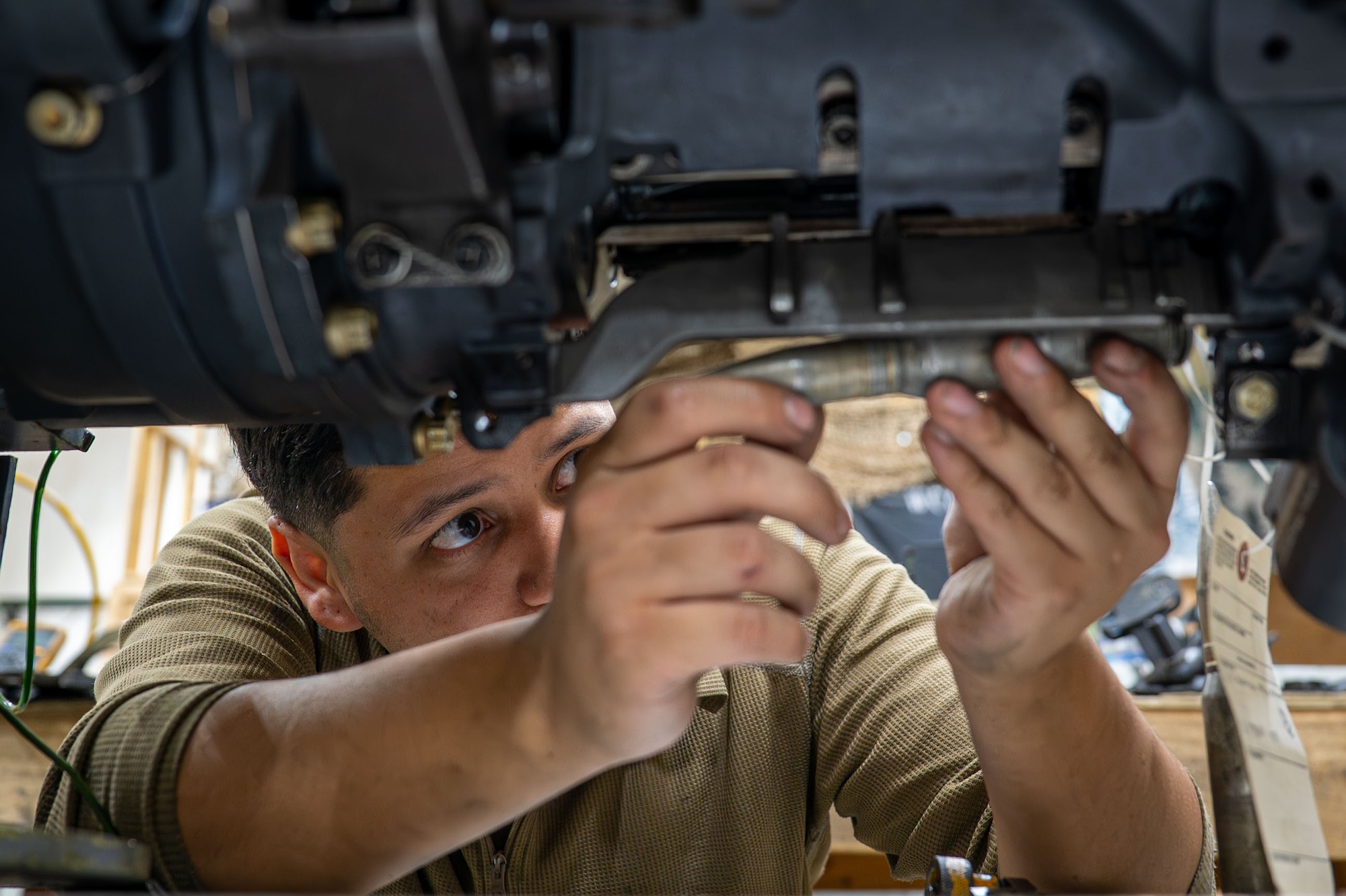 U.S. Air Force Senior Airman Kevin Estrada, 378th Expeditionary Maintenance Squadron armament maintenance member, loads a 20mm round into a M61A1 Gatling gun during an operations check.