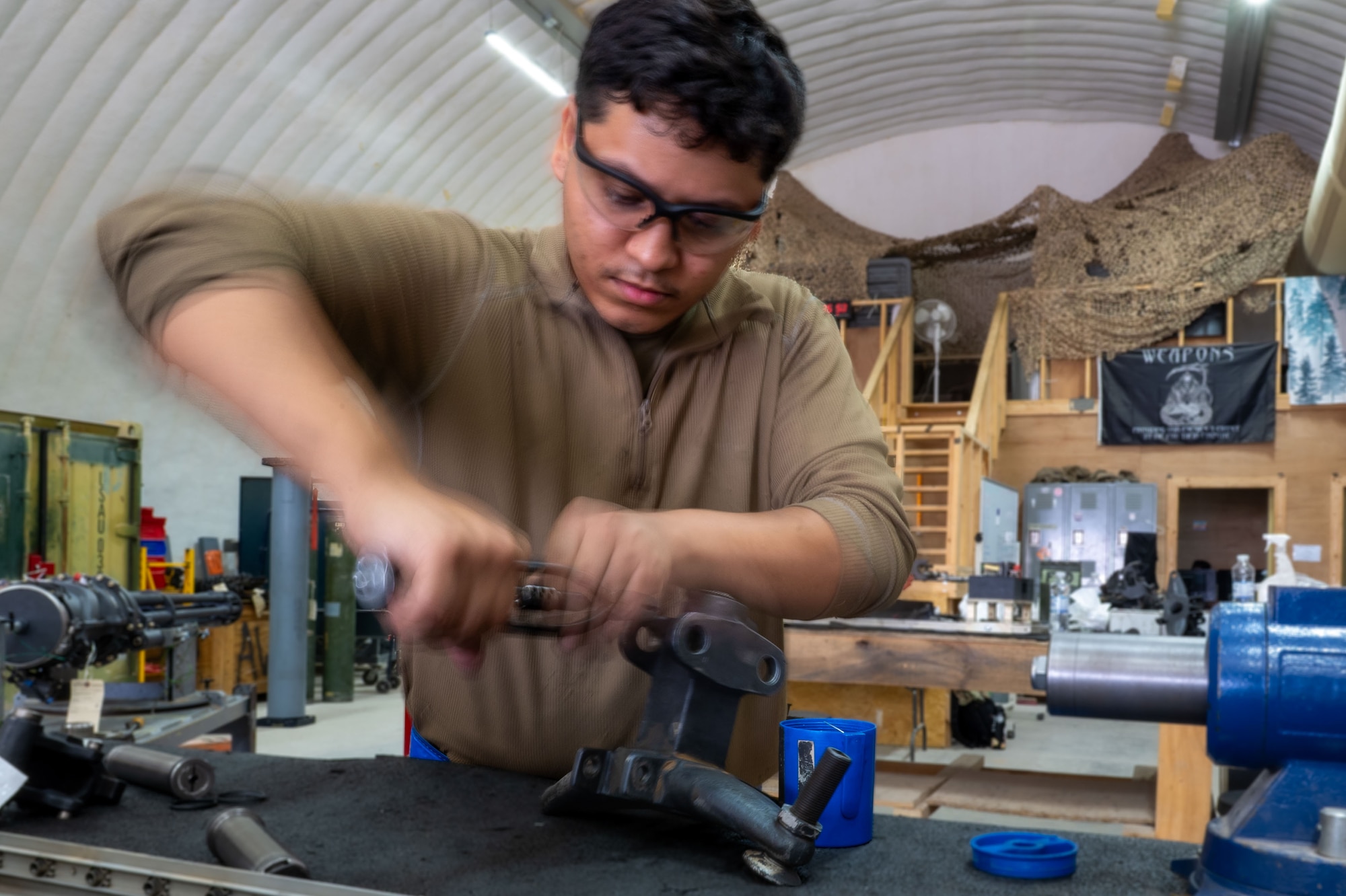 U.S. Air Force Senior Airman Kevin Estrada, 378th Expeditionary Maintenance Squadron armament maintenance member, secures a safety wire to a cylinder block bolt.