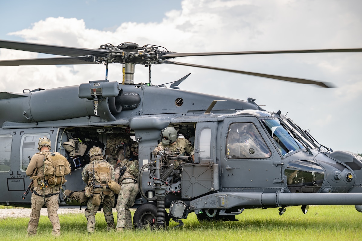 Pararescuemen assigned to the 38th Rescue Squadron load a simulated patient into an HH-60W Jolly Green II piloted by Col. Paul Sheets, 23rd Wing commander, at Moody Air Force Base, Ga., July 29, 2025. The training scenario was part of Sheets’ final flight with the wing, where pararescuemen performed Tactical Combat Casualty Care on a simulated patient before evacuation. (U.S. Air Force photo by Airman 1st Class Savannah Carpenter)