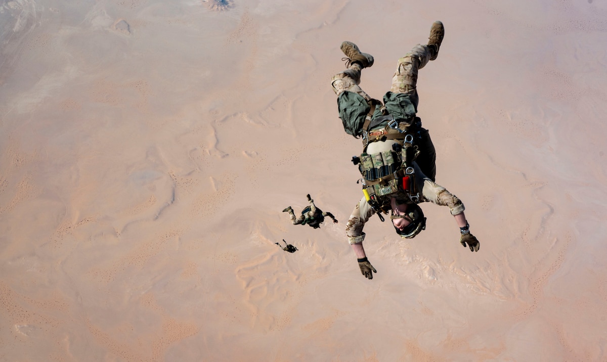 U.S. Air Force pararescuemen assigned to the 52nd Expeditionary Rescue Squadron execute a military free fall jump from an HC-130J Combat King II over the U.S. Central Command area of responsibility, Aug. 5, 2025. The high-altitude jump enables precision infiltration into contested or remote environments while minimizing detection. (U.S. Air Force photo by Senior Airman Natalie Jones)