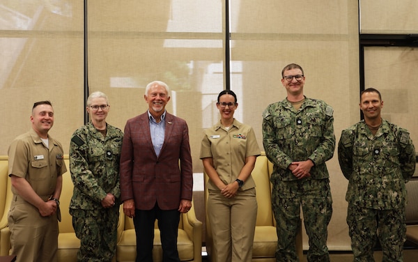U.S. Rep. Jack Bergman (MI-01) poses for a picture with fellow Michiganians during a visit to Naval Medical Center San Diego (NMCSD) Aug. 11. Bergman was visiting NMCSD to learn how they support readiness, health care delivery, and the Maxillofacial Restoration Program, an innovative initiative that is transforming dental readiness and patient’s lives. Bergman took a break during the visit to have lunch with Sailors from his home state. Pictured from left to right: Lt. Cmdr. Kyle Follebout, 5 West division officer and native of Hemlock, Michigan; Cmdr. Angela Viers, chief medical officer, neurosurgeon, and native of Royal Oak, Michigan; Bergman; Lt. Sydney Rouble, nurse, military/deployment health division officer, and native of DeWitt, Michigan; Cmdr. Eric Pasman, pediatric gastroenterologist, pediatric gastroenterology division officer, and native of Paw Paw, Michigan; and Cmdr. Benjamin Drew, anesthesiologist, associate anesthesia residency program director, and born in Farmington Hills, Michigan. (DOD photo by Regena Kowitz)