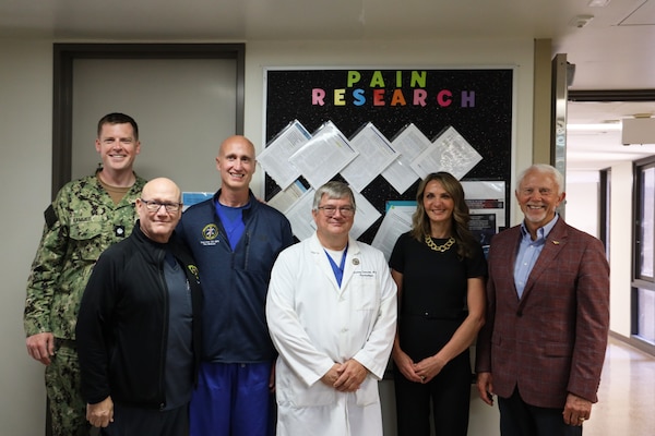 U.S. Rep. Jack Bergman, right, (MI-01) poses for a picture with staff from the pain clinic during a visit to Naval Medical Center San Diego (NMCSD) Aug. 11. Bergman was visiting NMCSD to learn how they support readiness, health care delivery, and the Maxillofacial Restoration Program, an innovative initiative that is transforming dental readiness and patient’s lives. Pictured from left to right: Cmdr. Daniel Hammer, oral maxillofacial surgeon and Maxillofacial Restoration Program manager; Wayne Pritchard, nurse; Lt. Cmdr. Ryan Scott, physician; Alane Costanzo, physician; and Bergman. (DOD photo by Regena Kowitz)