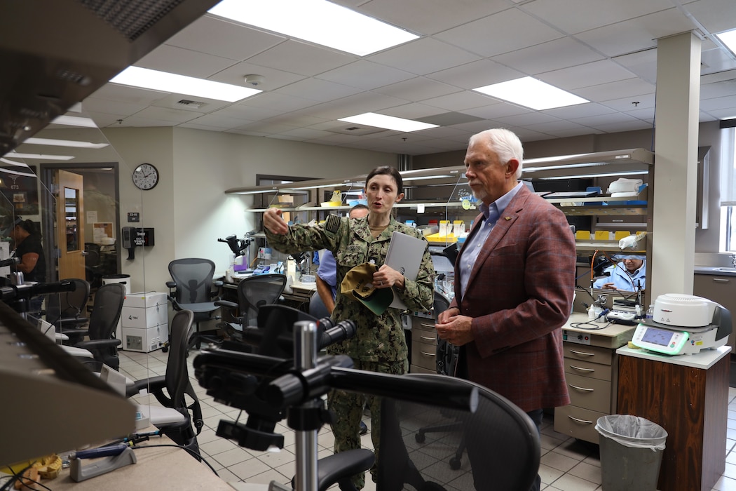 Cmdr. Danielle Marquis, prosthodontist, gives U.S. Rep. Jack Bergman (MI-01) a tour of the Defense Health Agency’s (DHA) regional dental laboratory on Naval Base San Diego Aug. 11. Marquis is the department head for DHA’s regional lab. Bergman was in San Diego to visit to Naval Medical Center San Diego (NMCSD) and learn how they support readiness, health care delivery, and the Maxillofacial Restoration Program, an innovative initiative that is transforming dental readiness and patient’s lives. The DHA regional dental lab fabricates dental prostheses and appliances and is located inside one of NMCSD’s branch dental clinics. (DOD photo by Regena Kowitz)
