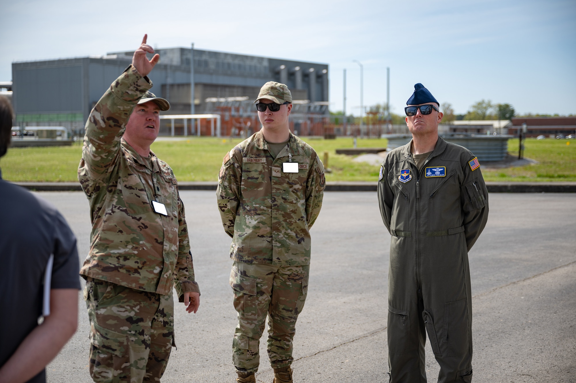 Lt. Col. Joshua Thomas, commander of the 717th Test Squadron, left, briefs Chief Master Sgt. Evan McCoy, right, on 717TS facilities and operations during McCoy’s April 17, 2025, visit to Arnold Air Force Base, Tenn., headquarters of Arnold Engineering Development Complex. Also pictured is Senior Airman Christopher Bradbury. McCoy officially assumed the role of AEDC Senior Enlisted Leader on Aug. 1, 2025. (U.S. Air Force photo by Keith Thornburgh) (This image was altered by obscuring badges for security purposes)