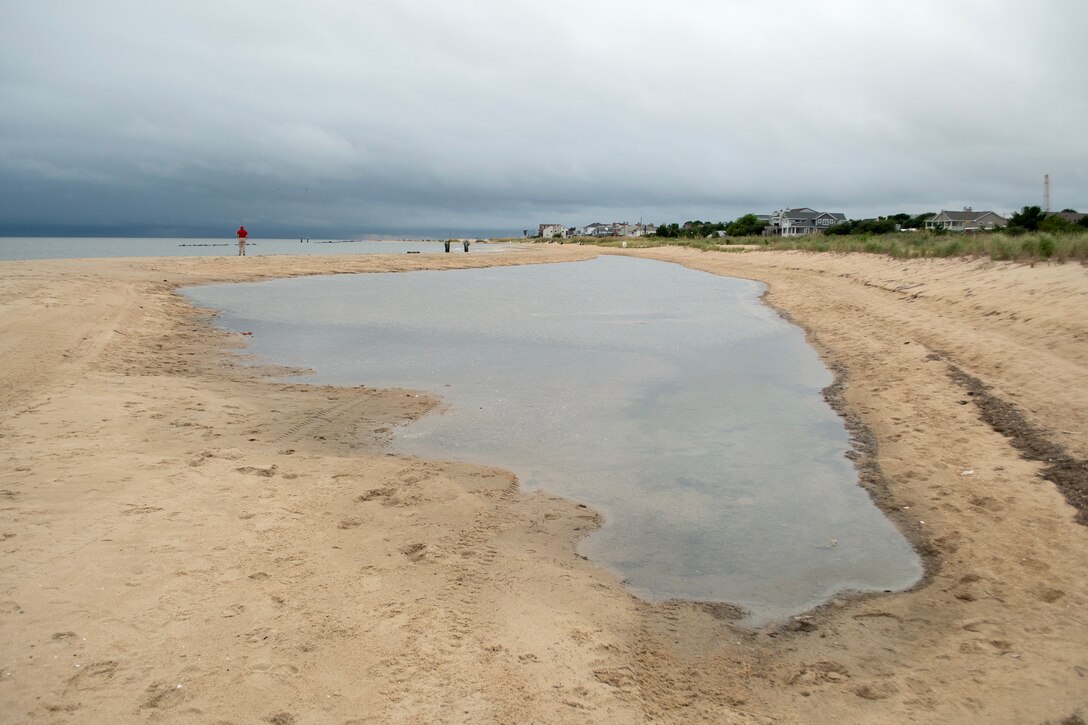 U.S. Army Corps of Engineers, Norfolk District hydraulics and hydrology engineer Ellen Cava, assesses pre-storm conditions at Willoughby Beach in Norfolk, Va. on Aug. 19, 2025. Cava, along with project managers Ryan Frye and Victor Roberts, also conducted inspections at Resort, Croatan, and Sandbridge beaches in Virginia Beach ahead of Hurricane Erin's projected impacts to the region. (U.S. Army photo by Alysia Rigano)