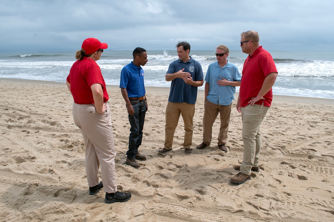 U.S. Army Corps of Engineers, Norfolk District project managers Victor Roberts and Ryan Frye, and hydraulics and hydrology engineer Ellen Cava, join City of Virginia Beach officials James White, program manager, and Ryan Firenze, Sandbridge renourishment project manager, for a discussion on current conditions at Croatan Beach, Virginia Beach, on Aug. 19, 2025. The group assessed shoreline conditions as part of pre-storm inspections conducted ahead of Hurricane Erin’s projected impacts. (U.S. Army photo by Alysia Rigano)