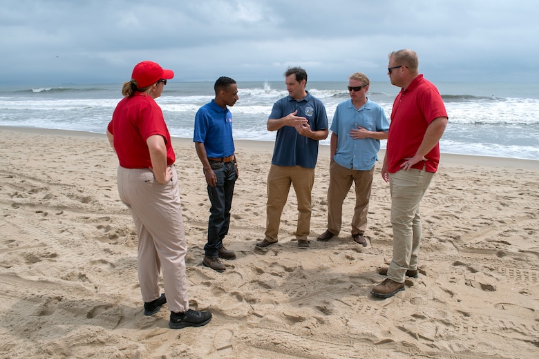U.S. Army Corps of Engineers, Norfolk District project managers Victor Roberts and Ryan Frye, and hydraulics and hydrology engineer Ellen Cava, join City of Virginia Beach officials James White, program manager, and Ryan Firenze, Sandbridge renourishment project manager, for a discussion on current conditions at Croatan Beach, Virginia Beach, on Aug. 19, 2025. The group assessed shoreline conditions as part of pre-storm inspections conducted ahead of Hurricane Erin’s projected impacts. (U.S. Army photo by Alysia Rigano)