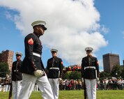 U.S. Marine Corps Cpl. Cameron Holmes, rifle inspector with the United States Marine Corps Silent Drill Platoon, Marine Barracks Washington, inspects Marines during a drill sequence at Boston Common in Boston, Aug. 21, 2025. The performance is part of Marine Week Boston, a community outreach event that brings Marines to cities across the country to showcase their traditions and capabilities. This year also marks the 250th birthday of the United States Marine Corps, a milestone celebrating two and a half centuries of honor, courage and commitment. (U.S. Marine Corps photo by Lance Cpl. Brynn L. Bouchard)