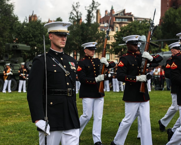U.S. Marine Corps Capt. Ford Higgins, platoon commander, United States Marine Corps Silent Drill Platoon, Marine Barracks Washington, marches alongside his platoon during a drill sequence at Boston Common in Boston, Aug. 21, 2025. Their performance is part of Marine Week Boston, a community outreach event that brings Marines to cities across the country to showcase their traditions and capabilities. This year also marks the 250th birthday of the United States Marine Corps, a milestone celebrating two and a half centuries of honor, courage and commitment. (U.S. Marine Corps photo by Lance Cpl. Brynn L. Bouchard)