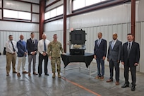 Col. Caleb Lewis (1st left of pelican case), Letterkenny Army Depot commander, and members of the LEAD command team, stand with Mike Pollut (1st right of pelican case), Unmanned Aircraft Systems Logistics Division chief, Dave Carter, UAS Sustainment director, and Ben White, UAS Product Support manager, after the opening ceremony at LEAD on Aug. 20.