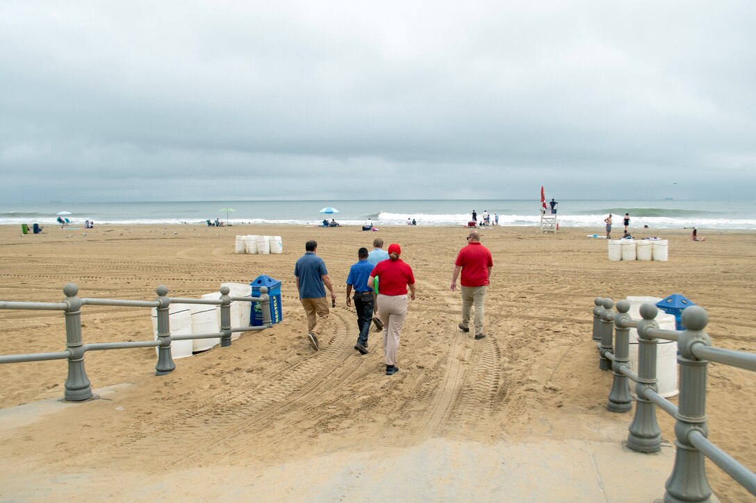 U.S. Army Corps of Engineers, Norfolk District project managers Victor Roberts and Ryan Frye, and hydraulics and hydrology engineer Ellen Cava, arrive at Resort Beach in Virginia Beach to assess conditions along with City of Virginia Beach partners, Ryan Firenze, the Sandbridge renourishment project manager, and James White, the Virginia Beach program manager. The team made four stops across three beaches in Virginia Beach to conduct pre-storm inspections ahead of Hurricane Erin's projected impacts. (U.S. Army photo by Alysia Rigano)