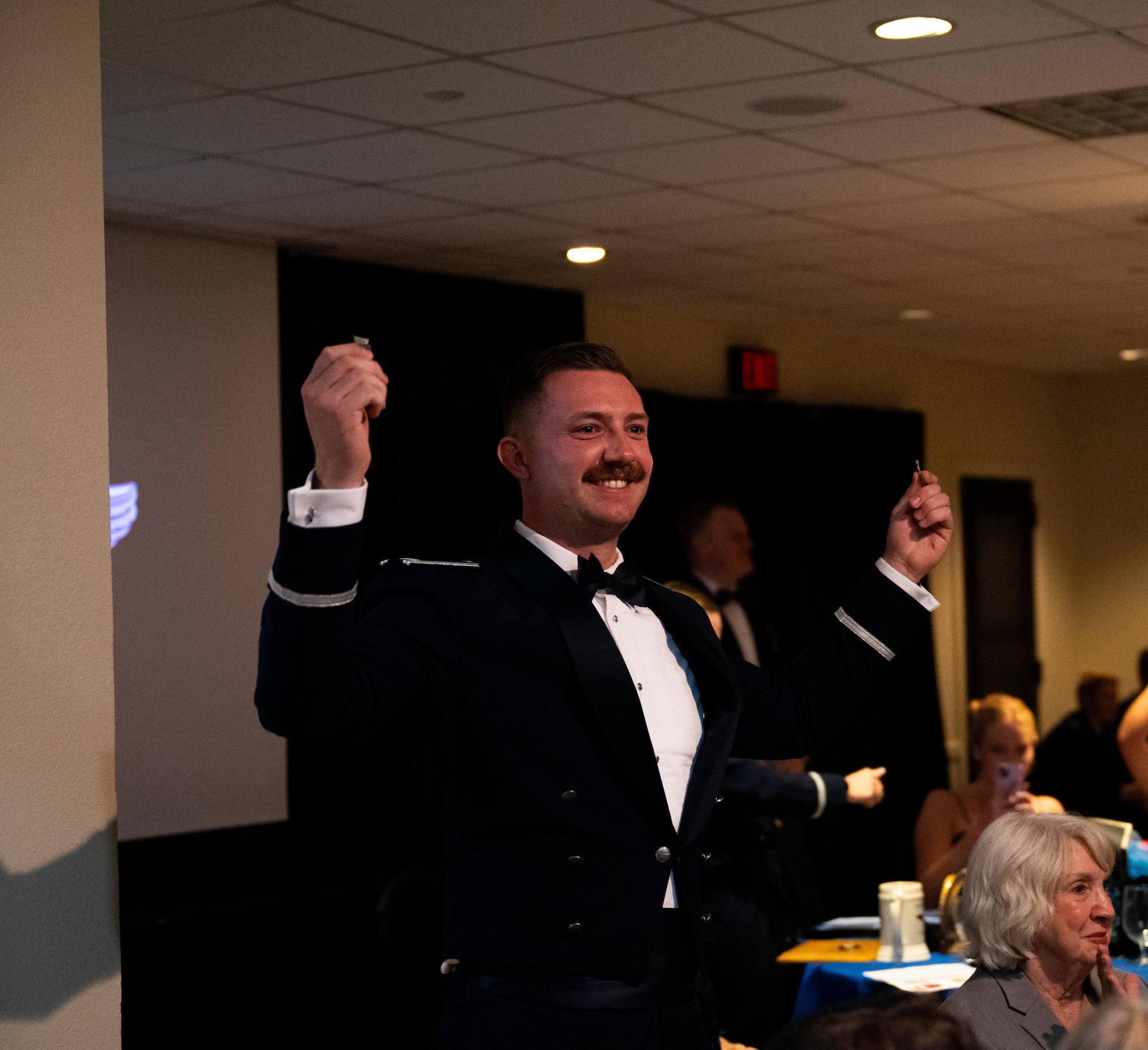 U.S. Air Force Airmen from graduating Class 25-14 break their wings at Laughlin Air Force Base, Texas, Aug. 21, 2025. Twenty-one U.S. Air Force officers were awarded silver wings during the ceremony, symbolizing their completion of the Undergraduate Pilot Training program. (U.S. Air Force photo by Airman 1st Class Harrison Sullivan)