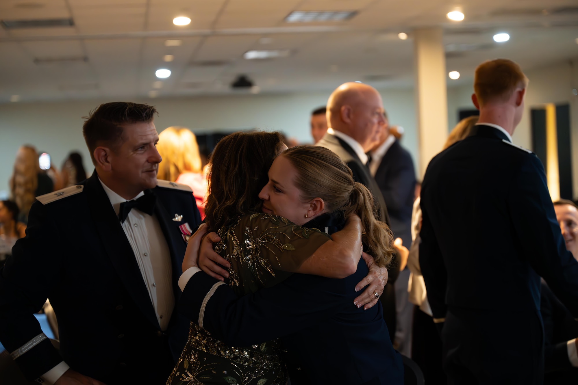 U.S. Air Force Airmen from graduating Class 25-14 present one half of their broken wings to their loved ones at Laughlin Air Force Base, Texas, Aug. 21, 2025.  Twenty-one U.S. Air Force officers were awarded silver wings during the ceremony, symbolizing their completion of the Undergraduate Pilot Training program. (U.S. Air Force photo by Airman 1st Class Harrison Sullivan)