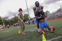 U.S. Marine Corps Sgt. Shannon Ruddy, a drill instructor with Mike Company, 3rd Recruit Training Battalion, Marine Corps Recruit Depot Parris Island, and a Blairstown, New Jersey native, directs a Randolph High School football player during a Marine Corps combat fitness test as part of Marine Week Boston, Aug. 21, 2025. During Marine Week Boston, Marines with Marine Corps Recruiting Command shared Marine Corps traditions with local high schools in honor of the Corps’ 250th birthday. Marines stationed across the globe commemorate the 250th anniversary of the Marine Corps, honoring a distinguished legacy of service, sacrifice, and unwavering fidelity to both the nation and fellow Marines. (U.S. Marine Corps photo by Sgt. Aidan Hekker)