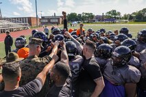 U.S. Marines with Marine Corps Recruiting Command huddle with the Randolph High School football team after a Marine Corps combat fitness test during Marine Week Boston, Aug. 21, 2025. During Marine Week Boston, Marines with Marine Corps Recruiting Command shared Marine Corps traditions with local high schools in honor of the Corps’ 250th birthday. Marines stationed across the globe commemorate the 250th anniversary of the Marine Corps, honoring a distinguished legacy of service, sacrifice, and unwavering fidelity to both the nation and fellow Marines. (U.S. Marine Corps photo by Sgt. Aidan Hekker)