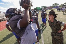 U.S. Marine Corps Sgt. Elizabeth McSparin, a drill instructor and Marine Corps Instructor of Water Survival with Bravo Company, 1st Recruit Training Battalion, Marine Corps Recruit Depot Parris Island, and Rock Island, Illinois native, motivates a Randolph High School football player during a Marine Corps combat fitness test as part of Marine Week Boston, Aug. 21, 2025. During Marine Week Boston, Marines with Marine Corps Recruiting Command shared Marine Corps traditions with local high schools in honor of the Corps’ 250th birthday. Marines stationed across the globe commemorate the 250th anniversary of the Marine Corps, honoring a distinguished legacy of service, sacrifice, and unwavering fidelity to both the nation and fellow Marines. (U.S. Marine Corps photo by Sgt. Aidan Hekker)