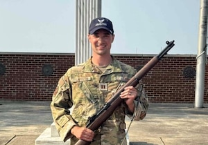 U.S. Air Force Capt. Seth Carozza, 14th Student Squadron Flight Commander and T-6A Texan II instructor Pilot, holds an M-1 Garand rifle.