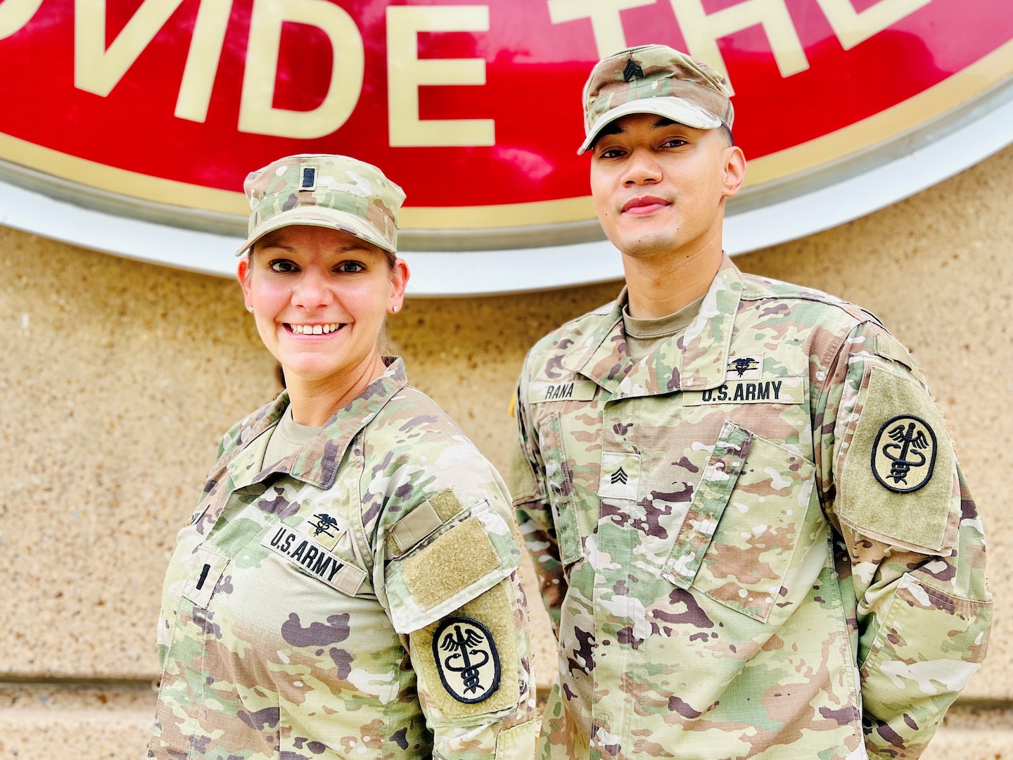 Two Soldiers posing in front of the BJACH sign.