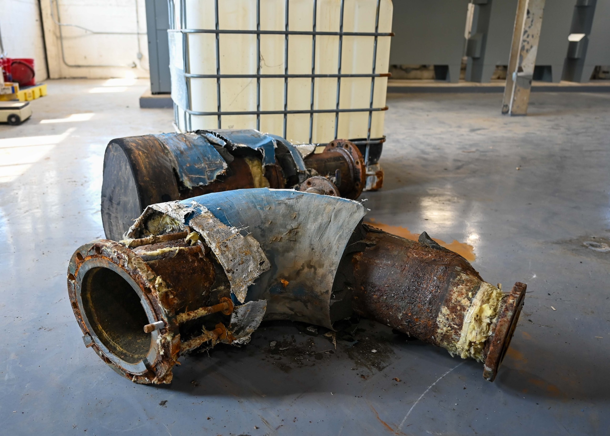Corroded pipe elbows sit on the floor of the Building 1410 chiller plant, at Maxwell Air Force Base, Ala., Thursday, Aug. 21, 2025. Corrosion was one of several problems that caused recent HVAC failures on the base. (U.S. Air Force photo by Senior Airman Tanner Doerr)