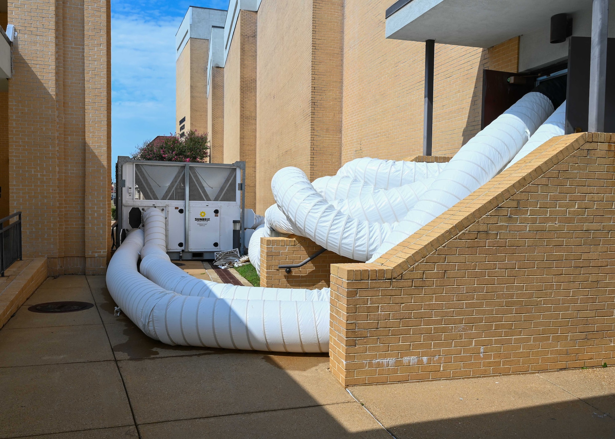 Ducts from a portable HVAC unit run into Squadron Officer School’s Polifka Auditorium, at Maxwell Air Force Base, Ala., Thursday Aug. 21, 2025. Temporary systems are being used to maintain cooling after multiple chiller failures on base.  (U.S. Air Force photo by Senior Airman Tanner Doerr)