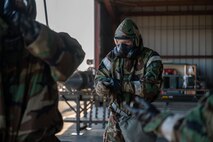U.S. Air Force Airmen assigned to the 48th Munitions Squadron put on their Mission Oriented Protective Posture gear as part of Operation Exterminator at Beale Air Force Base, California, Aug. 15, 2025.